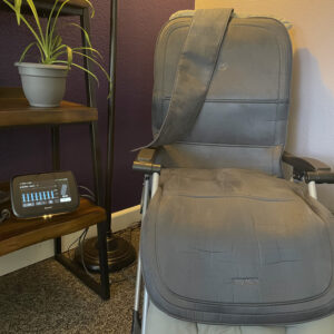 BEMER wellness technology setup in the Wholehearted Counseling office, with the B.Body on a chair and the control unit nearby.